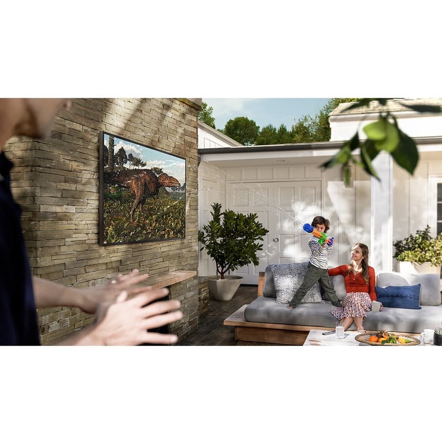 Samsung 65-inch Terrace QLED outdoor TV mounted on a patio wall