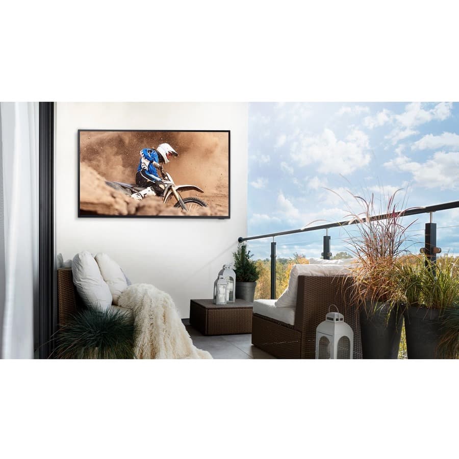 Samsung 65-inch Terrace QLED outdoor TV mounted on a patio wall